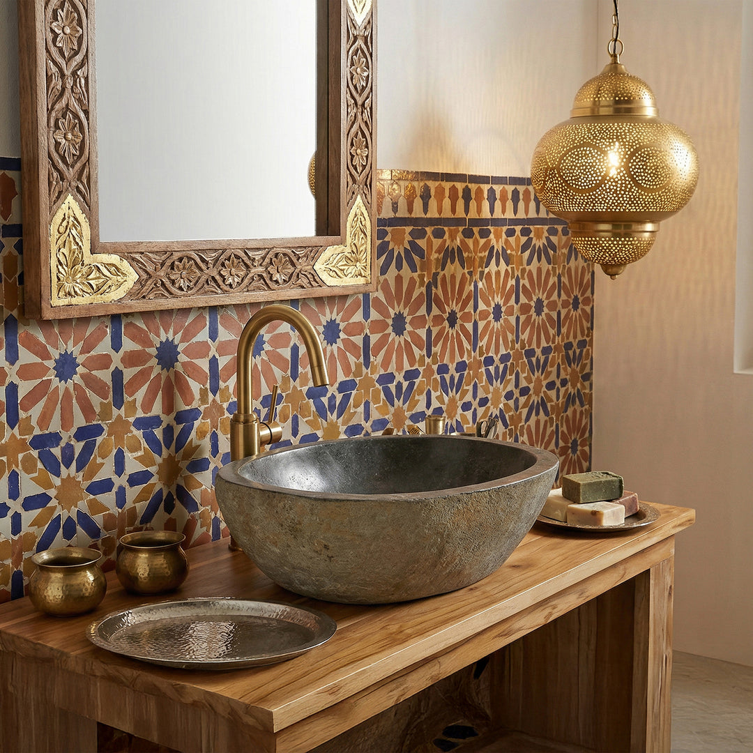 Rivier steen Wastafel in de oosterse badkamer op een houten console, gecombineerd met messing beslag, mozaïektegels en warm licht