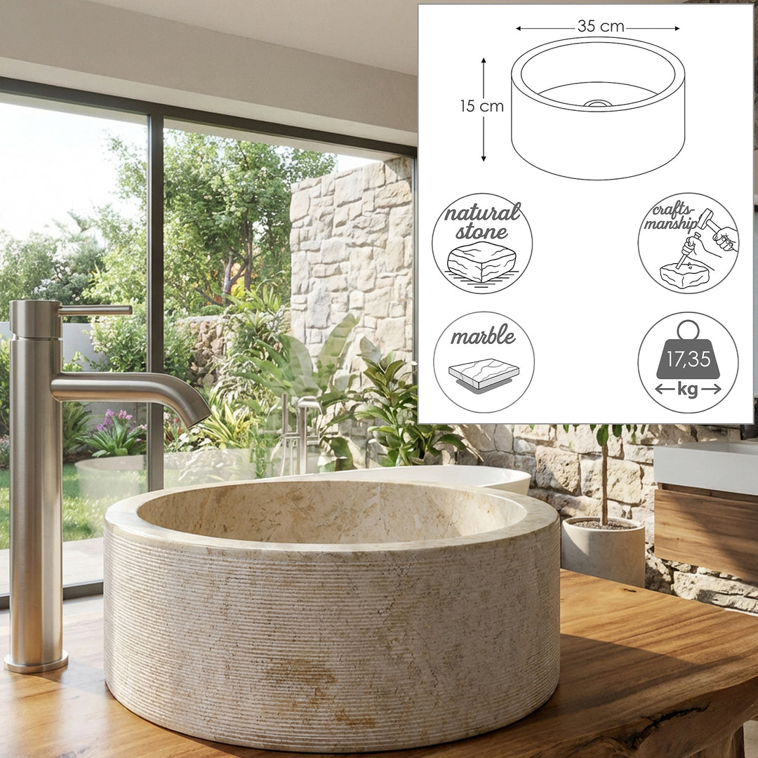 Ronde opzetwastafel van natuursteen met dimensionale afbeeldingen en materiaalsymbolen, gepresenteerd op een houten console in de lichte badkamer.